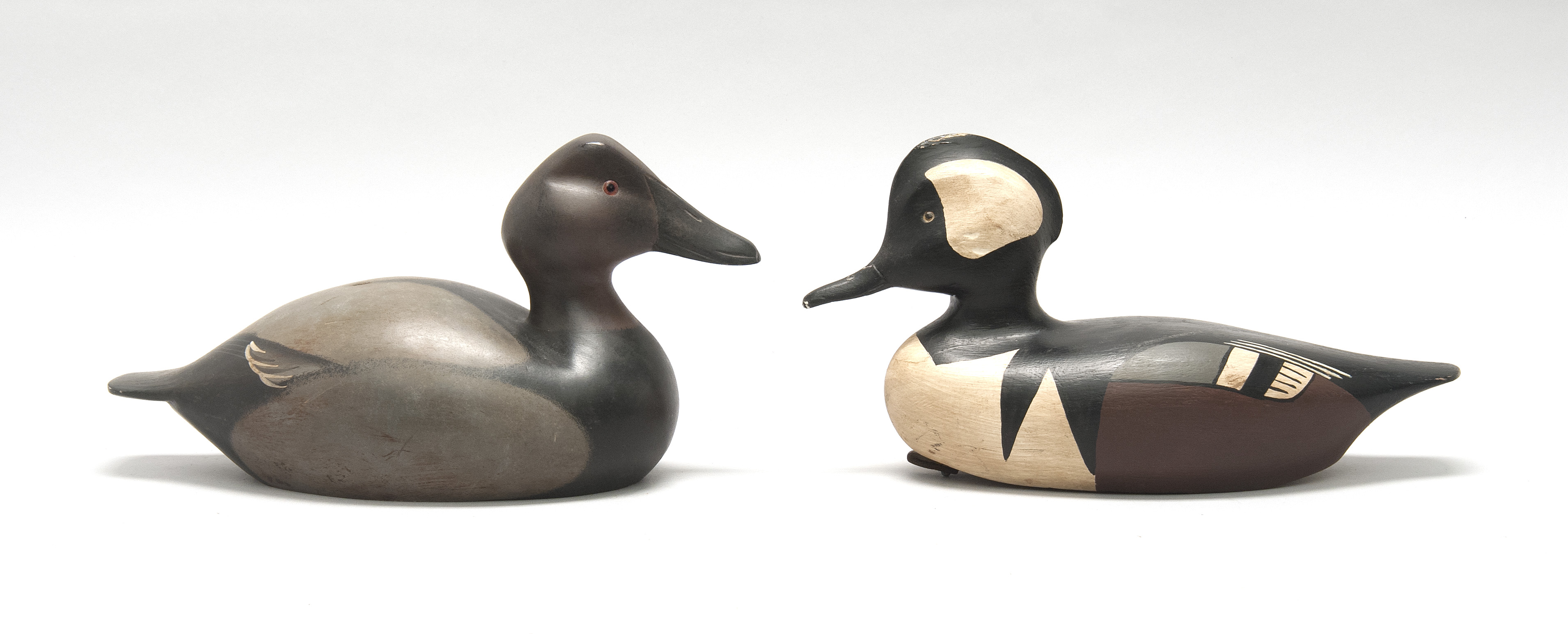 Appraisal: TWO WATERFOWL CARVINGS a hooded merganser drake decoy by Frank