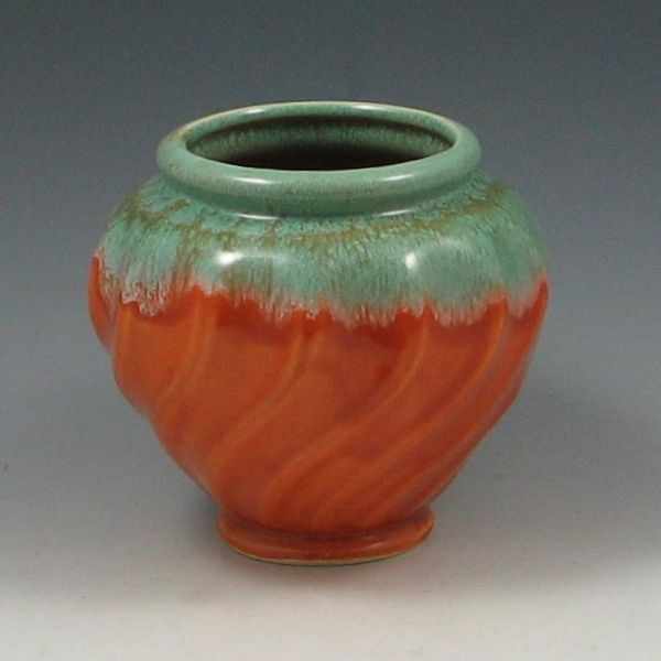 Appraisal: Hull swirl vase in green over orange Marked Swirl Urn-Vase