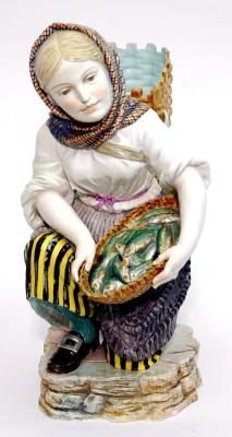 Appraisal: A CONTINENTAL MAJOLICA FIGURE modelled as a kneeling fishergirl wearing