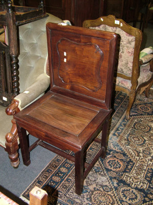 Appraisal: A Chinese hardwood side chair with panelled back and seat