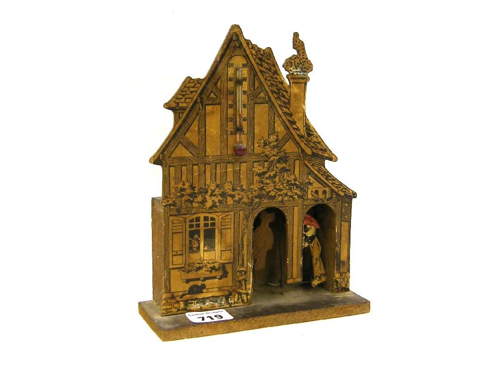 Appraisal: Stencilled wooden model of a gabled cottage with revolving automata