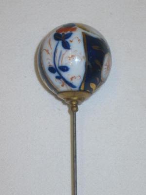 Appraisal: A PORCELAIN HAT PIN the ball end painted and gilded