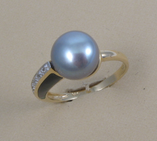 Appraisal: PEARL MOTHER-OF-PEARL AND DIAMOND RING k yellow gold and centering