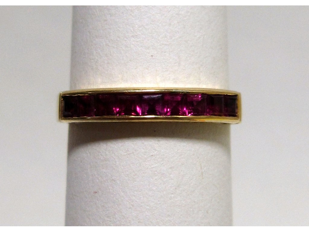 Appraisal: Eighteen carat gold calibre set ruby half hoop ring