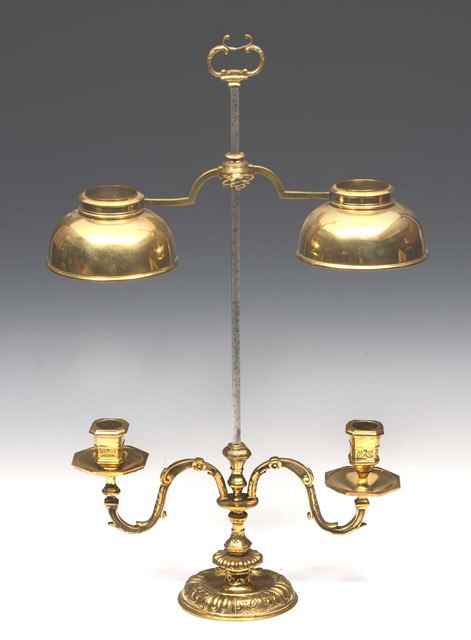 Appraisal: AN EMBOSSED BRASS TWIN BRANCH CANDLE HOLDER height adjustable on