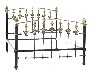 Appraisal: A BRASS-MOUNTED AND BLACK JAPANNED IRON BEDSTEAD the arched head