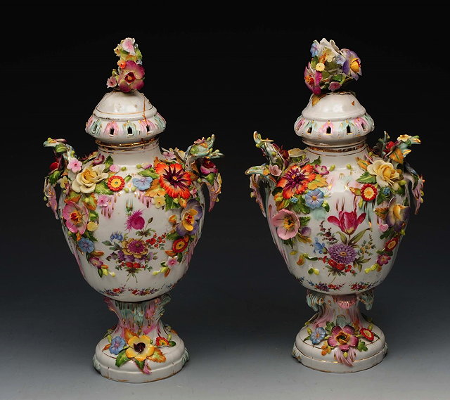 Appraisal: A PAIR OF TH CENTURY GERMAN PORCELAIN VASES AND COVERS