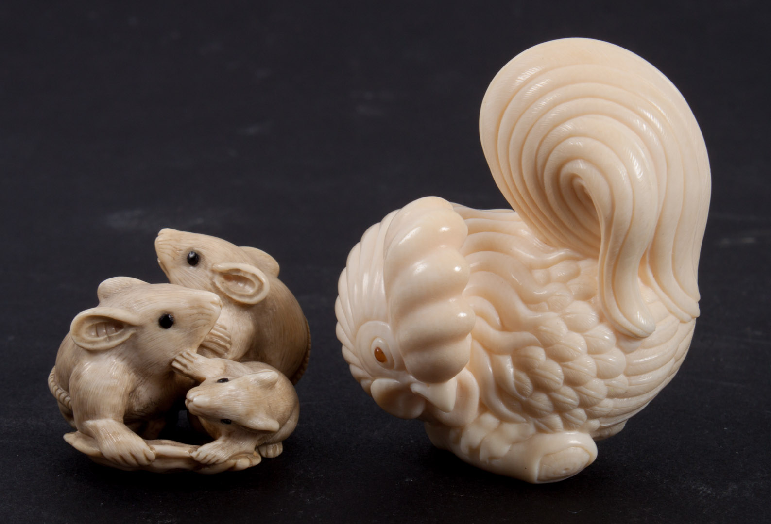 Appraisal: Two Japanese carved ivory netsukes comprising rooster signed in characters