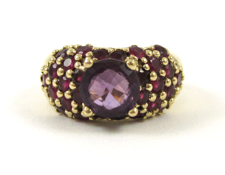 Appraisal: AMETHYST RUBY AND FOURTEEN KARAT GOLD RING set with round-cut