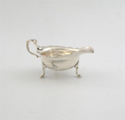 Appraisal: A George II cream boat on three legs with a