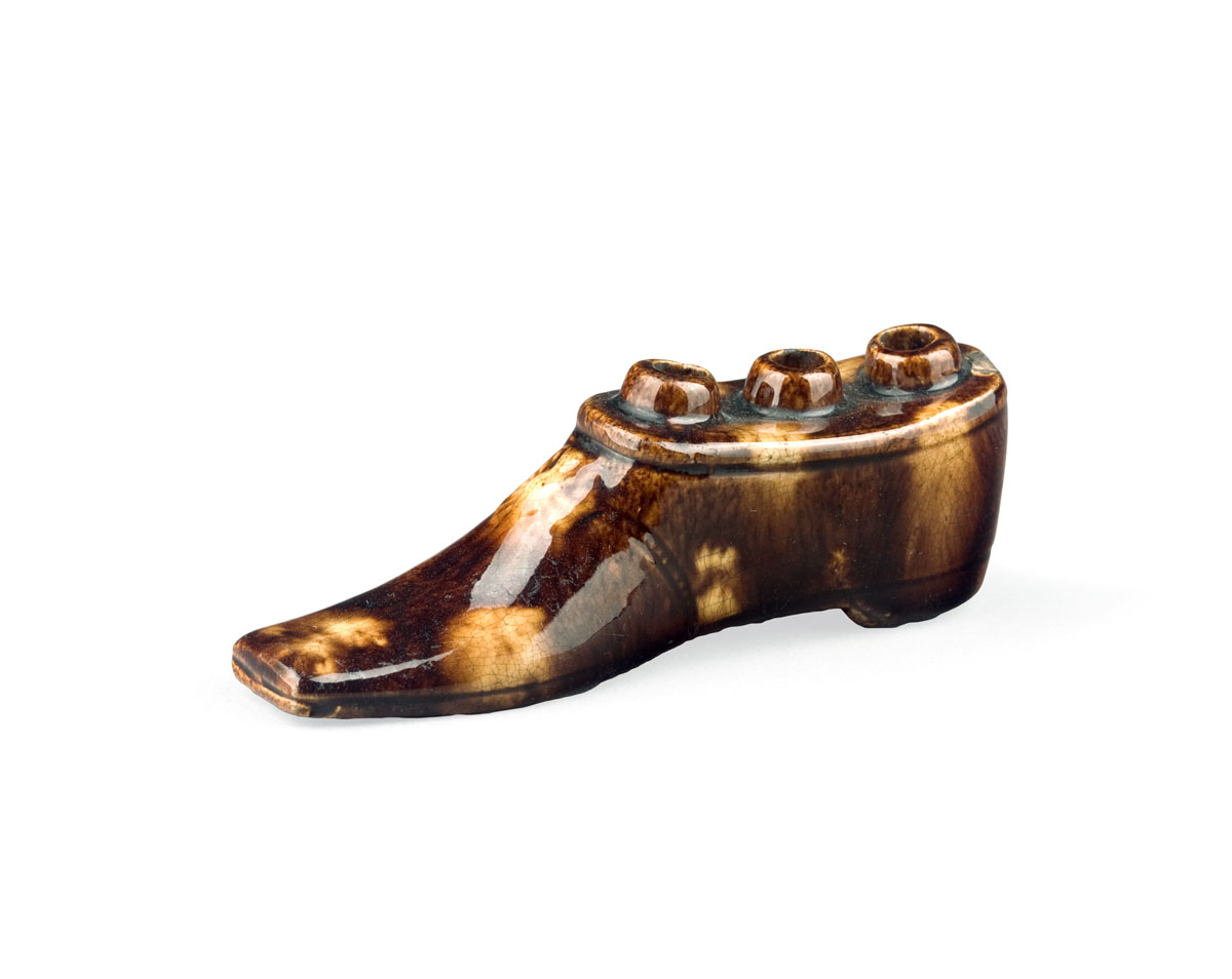 Appraisal: ENGLISH GLAZED EARTHENWARE SHOE-FORM QUILL HOLDER NINETEENTH CENTURY Modelled as