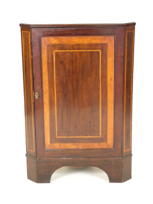 Appraisal: A mahogany corner cupboard late th century the crossbanded canted