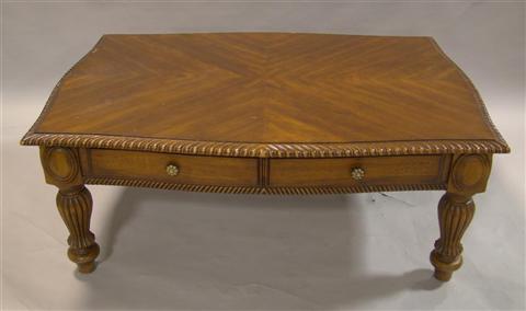 Appraisal: SHERATON STYLE MAHOGANY COFFEE TABLE th century the shaped rectangular