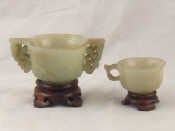 Appraisal: A carved jade two handled cup and another with single