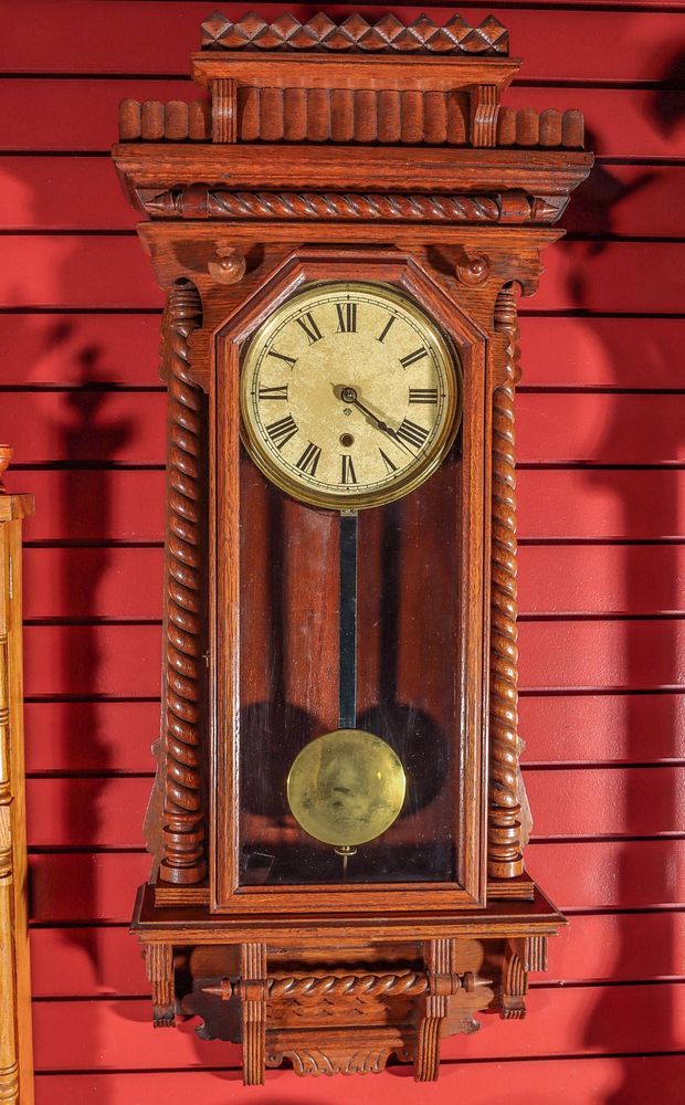 Appraisal: AN ANSONIA QUEEN ANN WALL CLOCK The ornate oak case