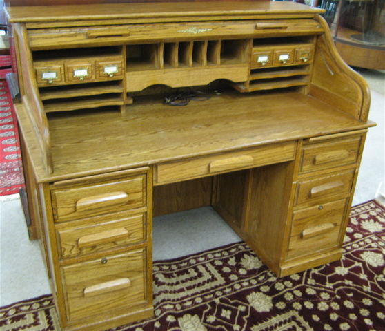 Appraisal: AN OAK ROLL TOP DESK WITH CHAIR antique reproduction the