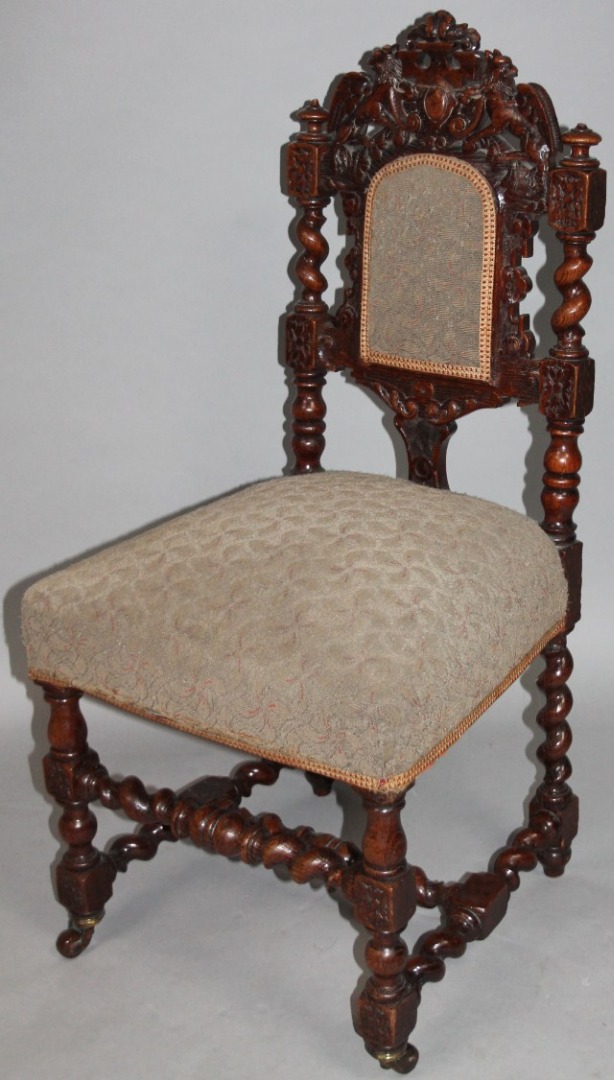 Appraisal: An thC heavily carved oak side chair the part overstuffed