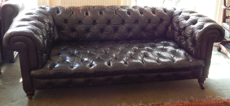 Appraisal: A Victorian Chesterfield sofa upholstered in buttoned dark brown vintage