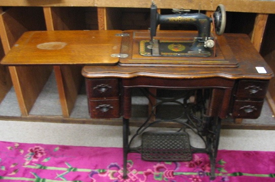 Appraisal: NEW HOME TREADLE SEWING MACHINE AND CABINET New Home Sewing