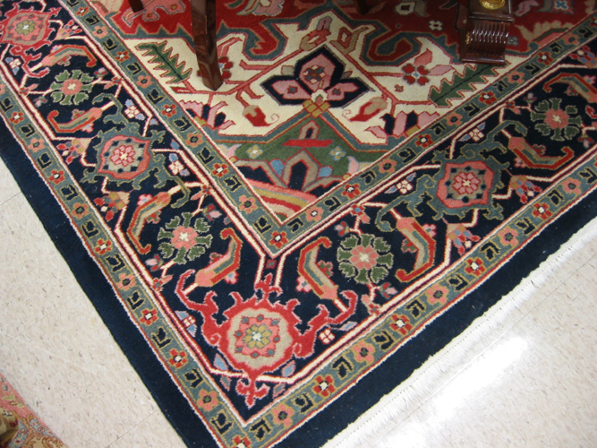 Appraisal: HAND KNOTTED ORIENTAL CARPET Indo-Heriz central geometric medallion and stylized