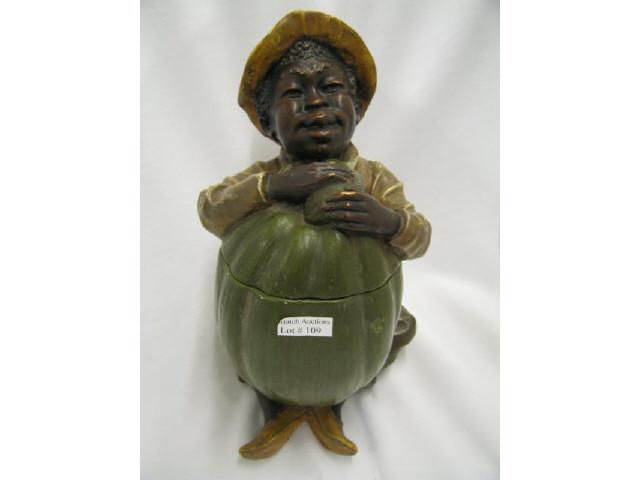 Appraisal: Black Americana Figural Pottery Tobacco Jar seated boy embracing a