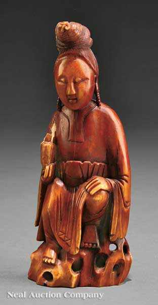 Appraisal: A Chinese Ivory Figure of Guanyin carved seated on a