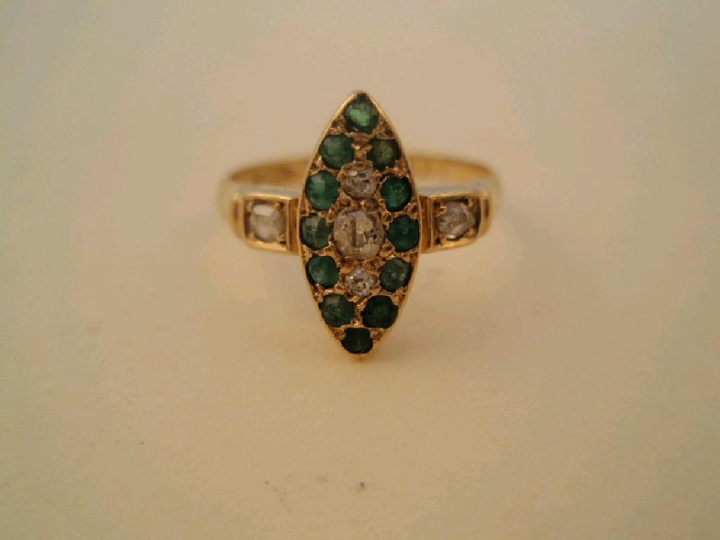 Appraisal: A marquise shaped cluster ring set with tiny emeralds and