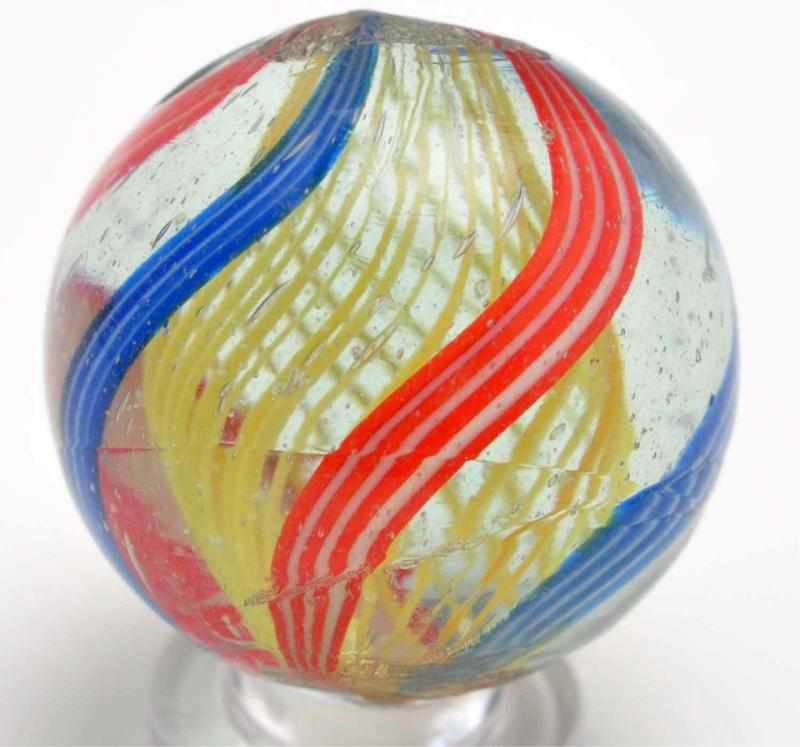 Appraisal: Yellow Latticino Swirl Marble Description Outer decorations are bands in