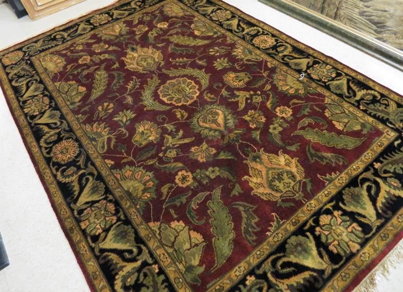 Appraisal: HAND KNOTTED ORIENTAL CARPET Indo-Persian floral arabesque decoration on plum