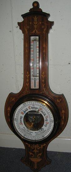 Appraisal: An Edwardian barometer and thermometer in a mahogany vase shaped