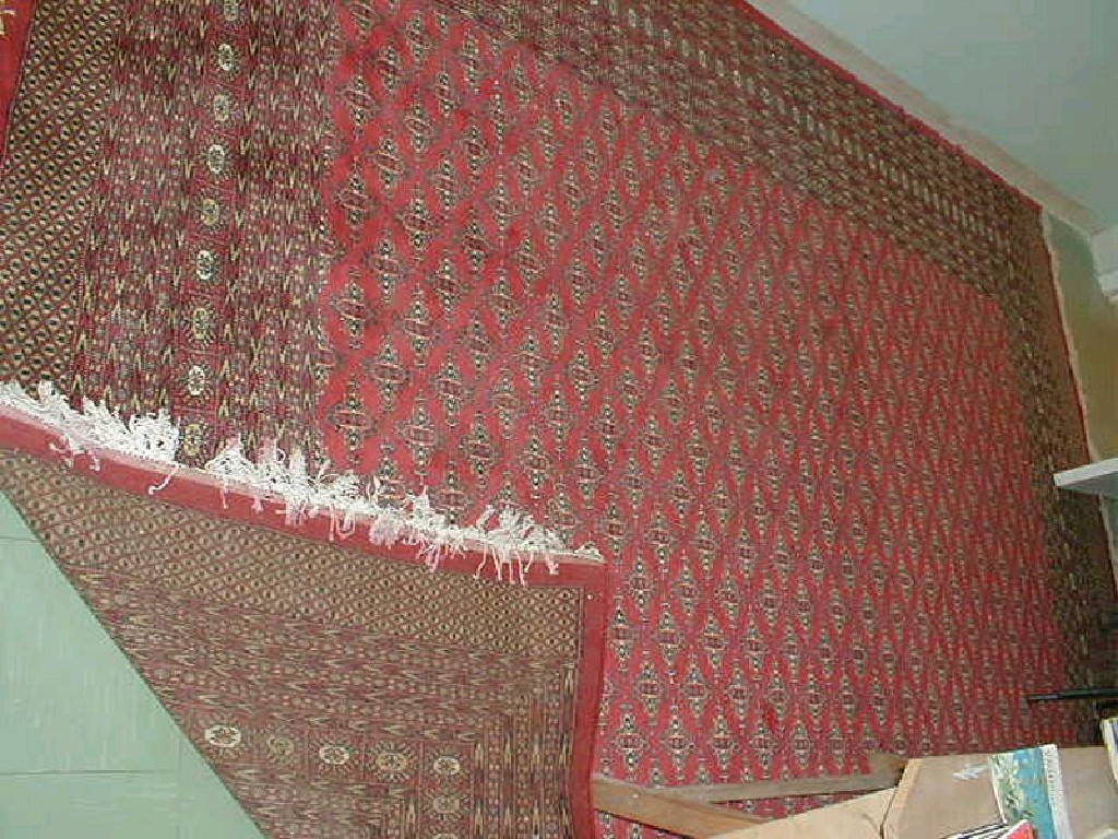 Appraisal: A red ground Pstan multi-gul and multi-border carpet cm x