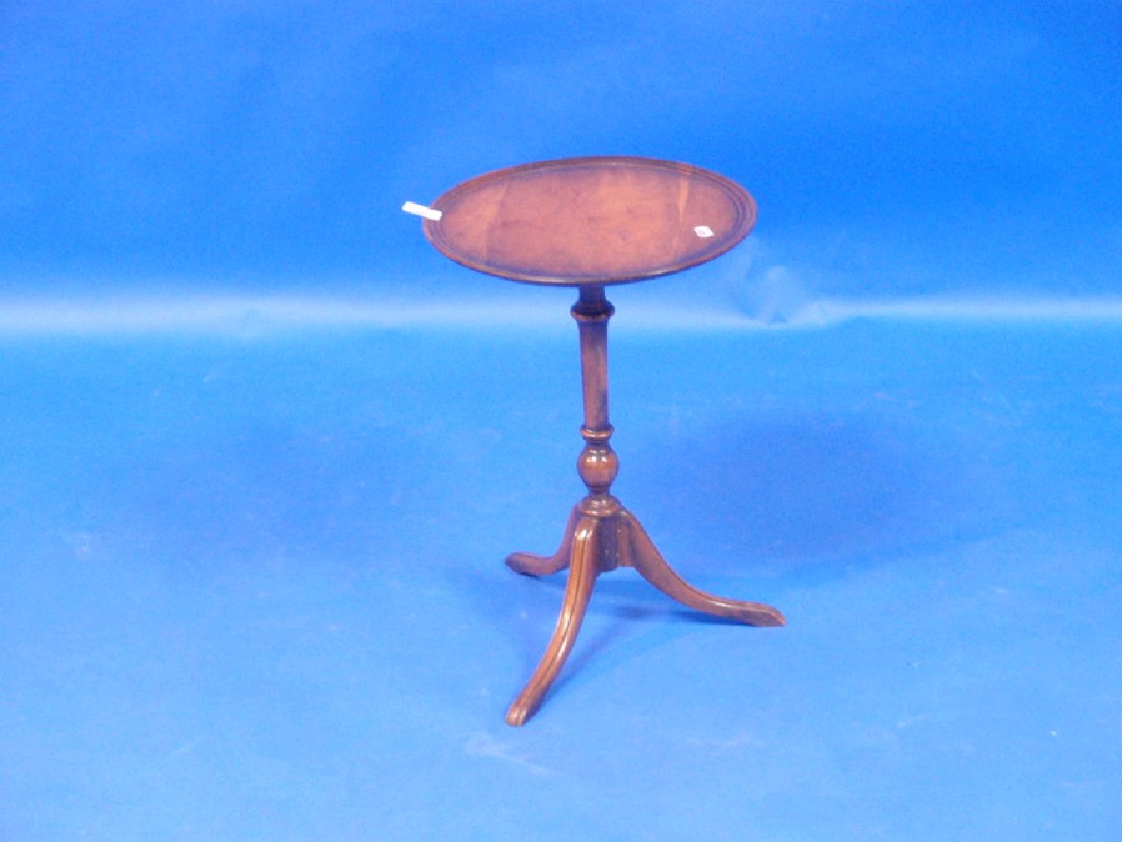 Appraisal: An antique yew circular tripod wine table with moulded border