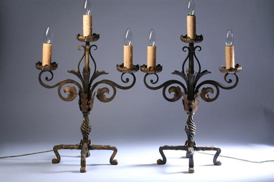 Appraisal: PAIR GILT-PAINTED WROUGHT-IRON THREE-LIGHT CANDELABRA th century Scrolling foliate branches