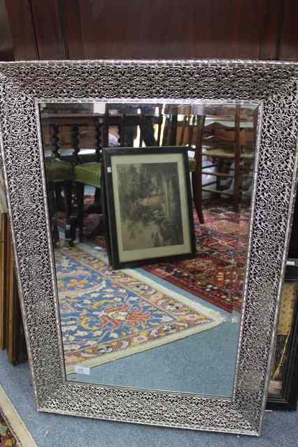 Appraisal: A RECTANGULAR WALL MIRROR with pierced white metal frame wide