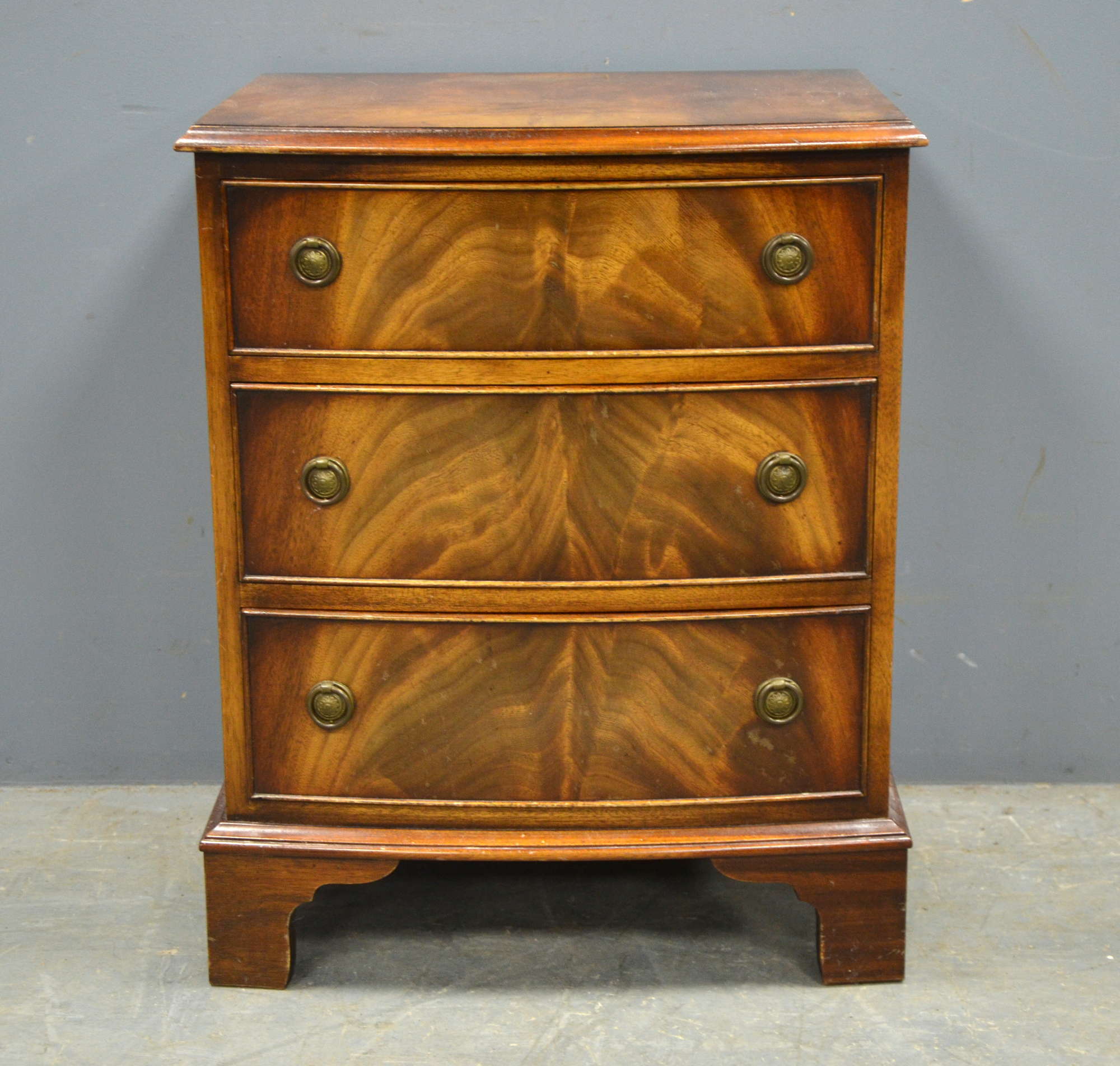 Appraisal: Reprodux mahogany three drawer bowfronted bedside chest