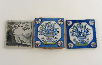 Appraisal: Three Delftware tiles two decorated with vases of flowers within