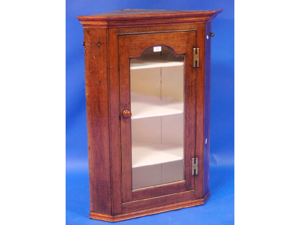 Appraisal: A Georgian oak hanging corner cupboard with glazed door and