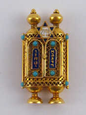 Appraisal: Judaica A yellow metal and enamel scroll holder charm marked