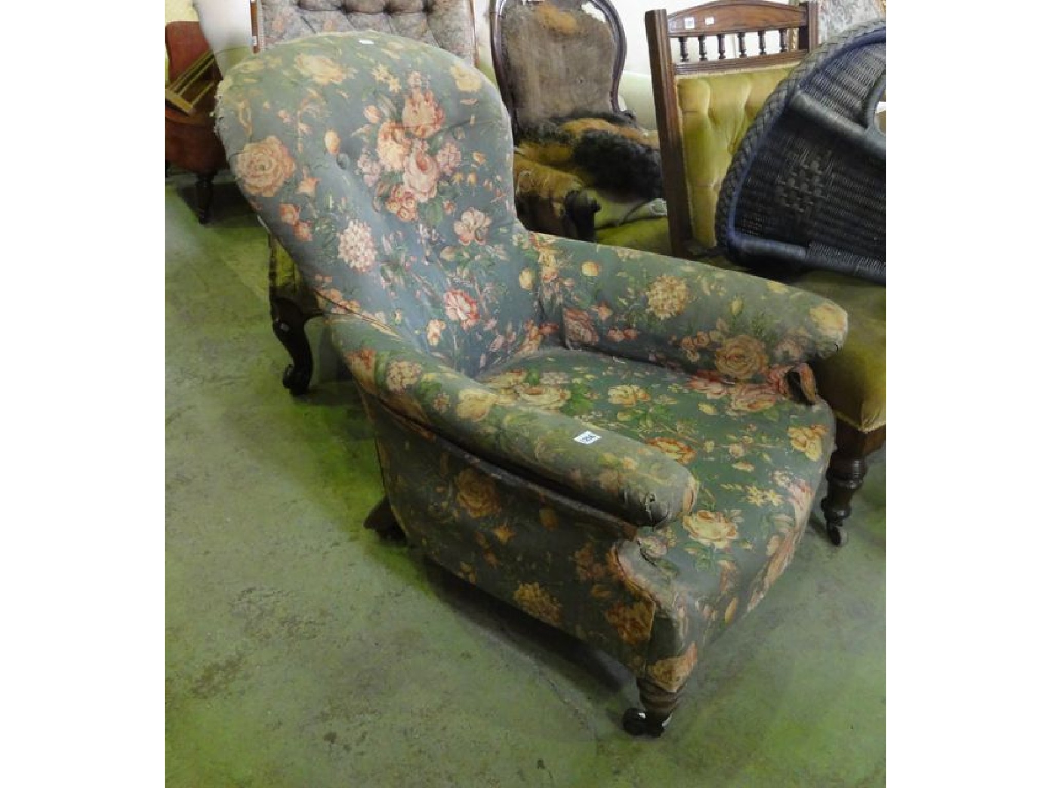 Appraisal: A Victorian low deep seated spoonback armchair with floral upholstered