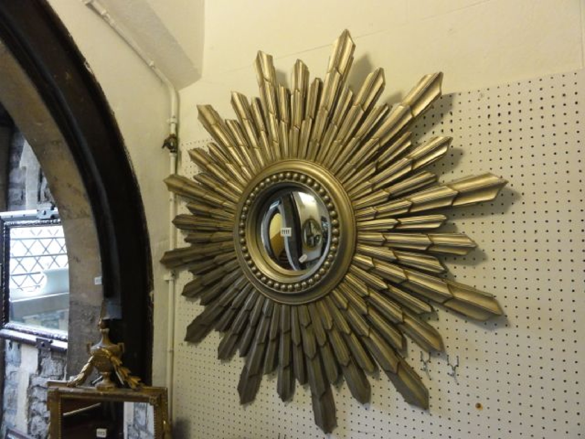 Appraisal: A contemporary convex wall mirror with painted composite sunburst frame