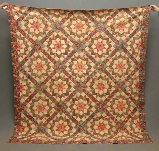 Appraisal: th c ''Carpenters Wheel'' quilt with chintz borders '' Square