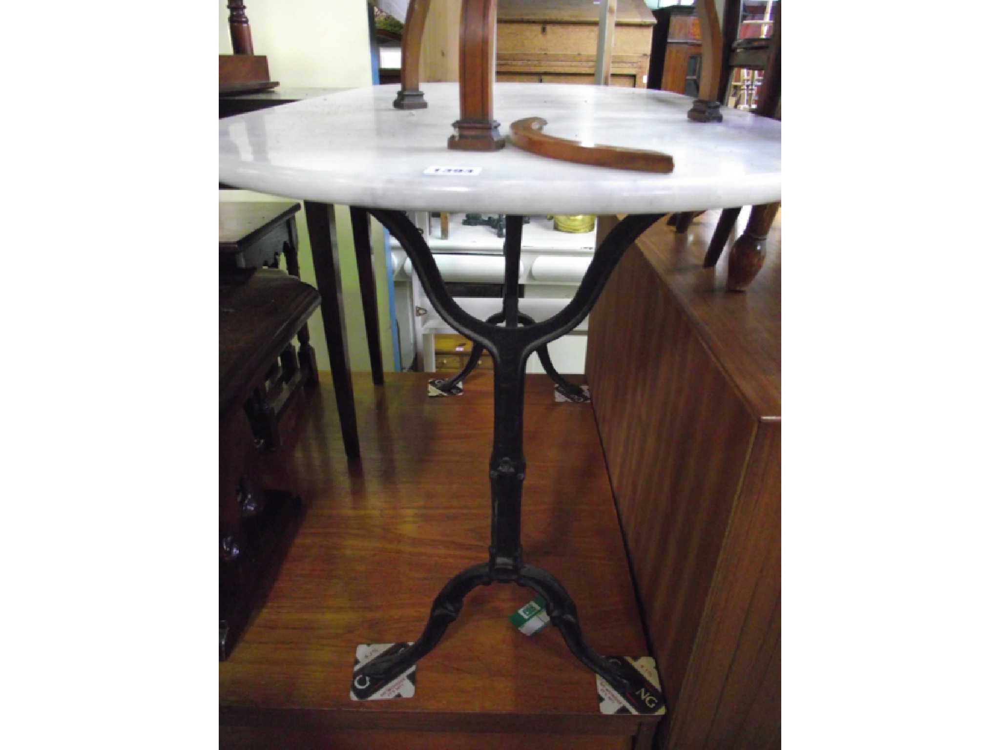 Appraisal: A Victorian cast iron framed occasional table with stretcher base