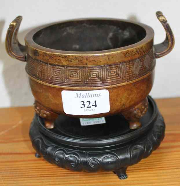 Appraisal: A JAPANESE BRONZE CENSER with flying handles geometric decoration and