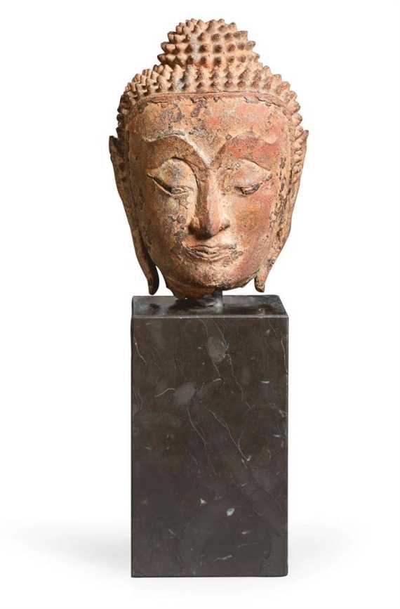 Appraisal: A SMALL BRONZE HEAD OF BUDDHA WITH SUBTLE FEATURES Thailand