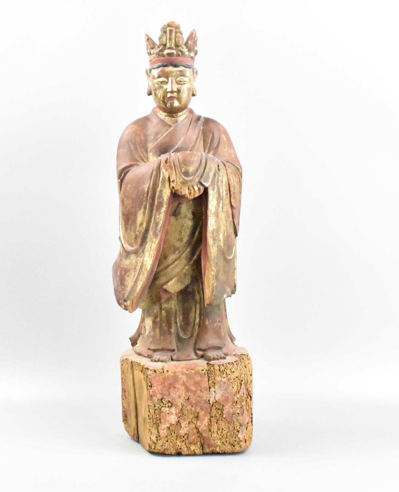 Appraisal: A Chinese Ming wood standing figurine The figurine stands on