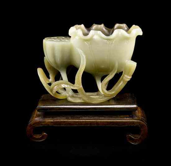 Appraisal: A Chinese Jade Carving of a Lotus of yellow-celadon colored