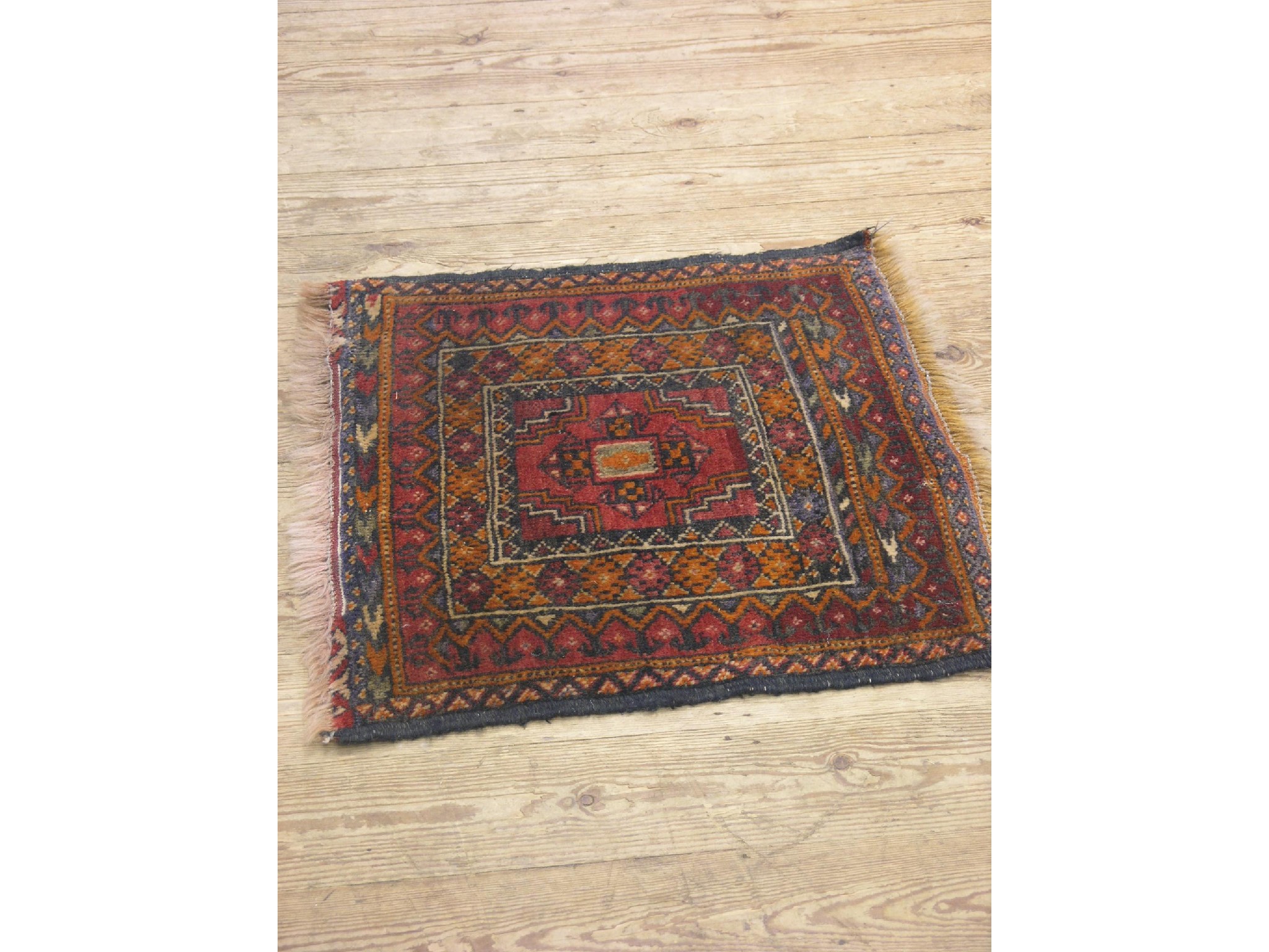 Appraisal: An Eastern wool prayer mat square-shape with multi-coloured geometric set-patterns