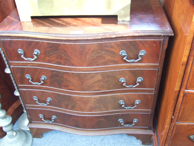 Appraisal: A reproduction mahogany serpentine chest of four long drawers raised