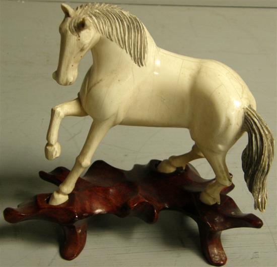 Appraisal: Early th century carved ivory horse h w in