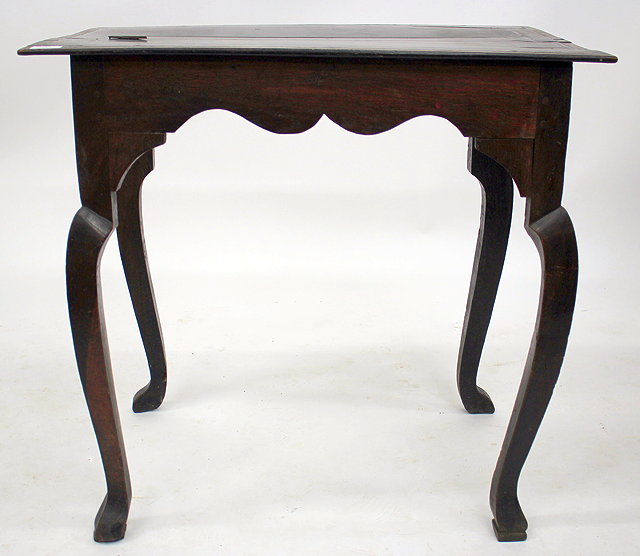 Appraisal: AN OLD OAK OCCASIONAL TABLE with shaped apron square section